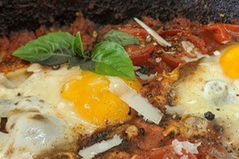 December eggs in purgatory recipe with crushed tomatoes, shallot, garlic and seasonings.