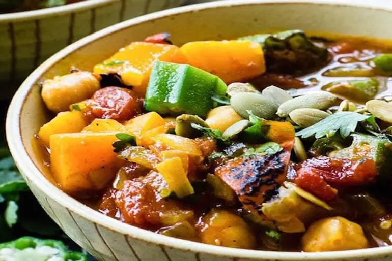 African Tomato Pumpkin Stew recipe served in a bowl, with chopped pumpkin, fire roasted tomatoes and okra.
